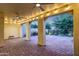 Spacious covered patio with brick pavers, illuminated by string lights and ceiling fans at 3467 N Hooper St, Buckeye, AZ 85396