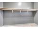 This walk-in closet offers ample storage space with built-in shelves and rods, as well as modern wood-look flooring at 3467 N Hooper St, Buckeye, AZ 85396