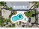 Aerial view of a backyard with a freeform pool, a spa, and an outdoor kitchen and dining area at 3646 W Brown St, Phoenix, AZ 85051