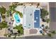 Aerial view of the home with a private pool, lush landscaping, and solar panels at 3646 W Brown St, Phoenix, AZ 85051