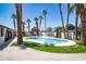 This backyard features a freeform pool, a spa, mature landscaping, and an outdoor kitchen and dining area at 3646 W Brown St, Phoenix, AZ 85051