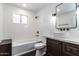 Bright bathroom with modern fixtures, subway tile, and a dark wood cabinet underneath the sink at 3646 W Brown St, Phoenix, AZ 85051