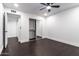 Bright bedroom with a ceiling fan, sliding door closet, dark wood floors, and an open entrance to another room at 3646 W Brown St, Phoenix, AZ 85051