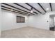 Bright bedroom with beams in the ceiling, a ceiling fan, tile floors, and a window with natural shades at 3646 W Brown St, Phoenix, AZ 85051