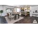 Staged dining room with stylish furnishings and kitchen with island in background at 3646 W Brown St, Phoenix, AZ 85051