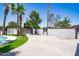 This backyard features a long driveway with a motorized gate and mature landscaping at 3646 W Brown St, Phoenix, AZ 85051