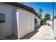 Exterior storage shed featuring white siding, well-manicured landscaping, and a paved driveway at 3646 W Brown St, Phoenix, AZ 85051