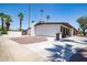 Exterior view of home with large concrete driveway, desert landscaping, and an attached fence at 3646 W Brown St, Phoenix, AZ 85051