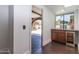 Hallway with wine fridge and view of backyard and pergola through an arched opening at 3646 W Brown St, Phoenix, AZ 85051