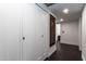 Hallway with white closet doors and dark wood floors, providing ample storage and a clean, modern aesthetic at 3646 W Brown St, Phoenix, AZ 85051