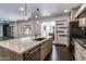Bright kitchen with stone countertops, pendant lights, and stainless steel appliances at 3646 W Brown St, Phoenix, AZ 85051