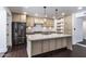 Modern kitchen boasts stainless steel appliances, a center island with sink, and custom cabinetry at 3646 W Brown St, Phoenix, AZ 85051