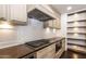 Gourmet kitchen features stainless steel appliances, custom cabinets, and high-end cooktop at 3646 W Brown St, Phoenix, AZ 85051