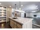 Kitchen featuring center island with seating, stainless steel appliances, and modern pendant lighting at 3646 W Brown St, Phoenix, AZ 85051