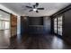 Living room with dark walls and wood accents, including barn door and built-in shelving at 3646 W Brown St, Phoenix, AZ 85051