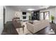 Staged living room featuring a fireplace, dark floors and custom built-in shelving at 3646 W Brown St, Phoenix, AZ 85051