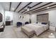 This main bedroom features wood beam ceilings, a ceiling fan, and access to the main bathroom at 3646 W Brown St, Phoenix, AZ 85051