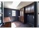 Inviting mud room featuring dark wood floors and cabinets, offering practical storage and access to the outdoors at 3646 W Brown St, Phoenix, AZ 85051