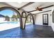 This outdoor living area features a covered patio with brick arches leading to the pool at 3646 W Brown St, Phoenix, AZ 85051