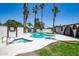 Private backyard oasis showcasing a sparkling pool, jacuzzi, surrounding patio, and well-manicured landscaping at 3646 W Brown St, Phoenix, AZ 85051