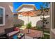 Charming backyard patio features a seating area, a shade umbrella, and well-maintained landscaping at 3783 E Stiles Ln, Gilbert, AZ 85295