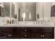 Bathroom features a large mirror with and sinks and dark wood cabinets at 3783 E Stiles Ln, Gilbert, AZ 85295