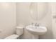 Clean and simple half bathroom with pedestal sink and neutral decor at 3783 E Stiles Ln, Gilbert, AZ 85295