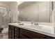 Well-lit bathroom features a double sink vanity with dark cabinets, creating a functional and stylish space at 3783 E Stiles Ln, Gilbert, AZ 85295