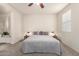 Bright bedroom with a ceiling fan, large bed and carpeted floors at 3783 E Stiles Ln, Gilbert, AZ 85295