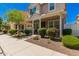 Delightful home exterior features a covered porch, beautiful shrubbery, and a welcoming facade at 3783 E Stiles Ln, Gilbert, AZ 85295