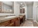 Well-lit bathroom features double sinks, decorative mirrors, and tile countertops and flooring at 3824 E Parkside Ln, Phoenix, AZ 85050