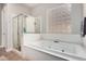 Bathroom features a glass shower and a separate soaking tub with a glass block window at 3824 E Parkside Ln, Phoenix, AZ 85050