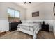 Comfortable bedroom featuring a large window, a ceiling fan and base ball decorations at 3824 E Parkside Ln, Phoenix, AZ 85050