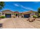 Charming single-story home with a desert landscape, a spacious driveway and a three-car garage at 3824 E Parkside Ln, Phoenix, AZ 85050