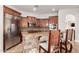 Modern kitchen featuring stainless steel appliances, granite countertops, and wooden bar stools at 3824 E Parkside Ln, Phoenix, AZ 85050