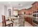 A kitchen boasts stone counter seating, tiled floors, and stainless steel appliances, offering modern elegance at 3824 E Parkside Ln, Phoenix, AZ 85050