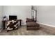 View of living room with modern furniture, carpet, and a contemporary entertainment center at 3824 E Parkside Ln, Phoenix, AZ 85050