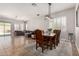 An open-concept space includes a dining area and a living room with neutral tones and ample natural light at 3824 E Parkside Ln, Phoenix, AZ 85050