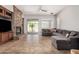 Living room featuring a stone fireplace, and a comfortable sectional couch near a sliding glass door to the patio at 3824 E Parkside Ln, Phoenix, AZ 85050