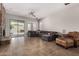 A spacious living room with tiled floors, a stone fireplace, and a large sectional couch for relaxing at 3824 E Parkside Ln, Phoenix, AZ 85050