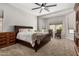 A primary bedroom features plush carpet, a large bed, and ample natural light for a restful retreat at 3824 E Parkside Ln, Phoenix, AZ 85050