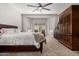 Spacious main bedroom features a cozy seating area, a ceiling fan and a beautiful dresser at 3824 E Parkside Ln, Phoenix, AZ 85050