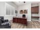 Bright home office features a dark wood desk, plantation shutters and built-in cabinets at 3824 E Parkside Ln, Phoenix, AZ 85050