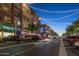 Charming street view of businesses at twilight, enhanced by decorative string lights at 3824 E Parkside Ln, Phoenix, AZ 85050