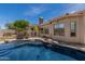 Beautiful backyard swimming pool, desert landscaping, mature trees, and wrought iron fencing at 3824 E Parkside Ln, Phoenix, AZ 85050