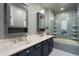 Stylish bathroom featuring dual sinks and tub with a glass enclosure at 3935 E Rough Rider Rd # 1164, Phoenix, AZ 85050