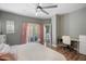 Bright bedroom featuring a sliding glass door, desk, and wood-look floors at 3935 E Rough Rider Rd # 1164, Phoenix, AZ 85050