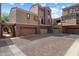 Lovely townhome showing garage access, exterior finishes, and pavers at 3935 E Rough Rider Rd # 1164, Phoenix, AZ 85050