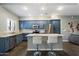 Kitchen features an island with seating and granite countertops and stainless steel appliances at 3935 E Rough Rider Rd # 1164, Phoenix, AZ 85050