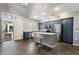 Spacious kitchen featuring an island with seating, modern appliances, and custom cabinetry at 3935 E Rough Rider Rd # 1164, Phoenix, AZ 85050